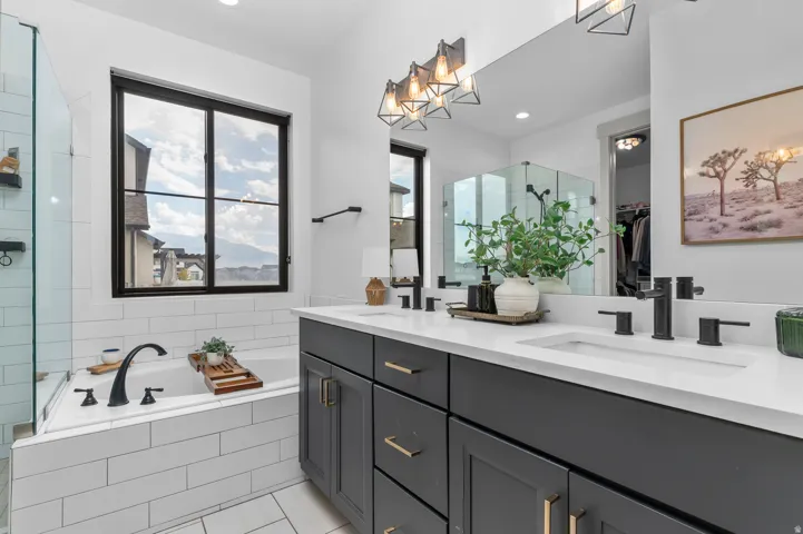 Double vanity with white countertop, undermount sinks, and matte black fixtures