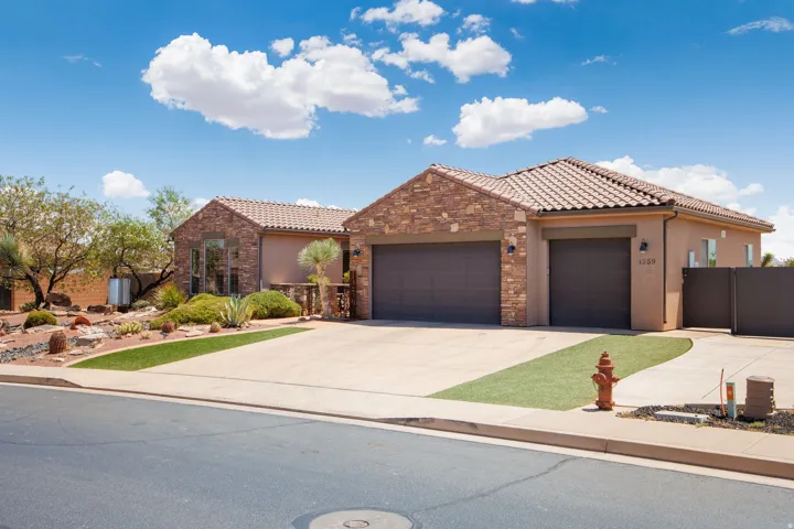 Desert contemporary residence featuring a stone facade and a tiled roofline