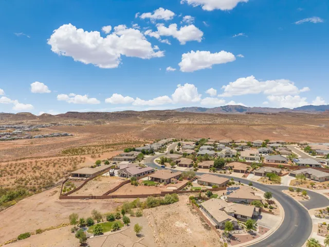 Residential community featuring single-story homes with tile roofs, surrounded by natural desert landscaping
