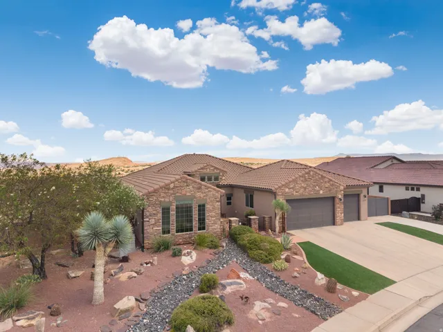 Southwestern-style home featuring a stone facade and tile roofing