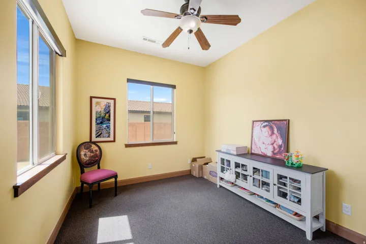 Room featuring vaulted ceilings and a ceiling fan