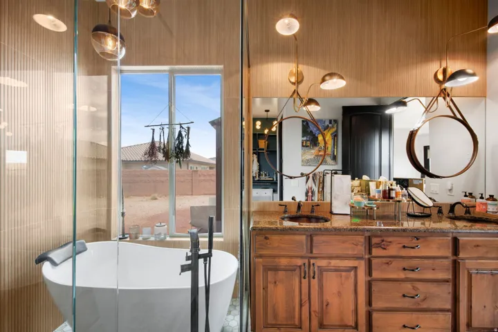 Freestanding soaking tub with a floor-mounted faucet, complemented by a large window