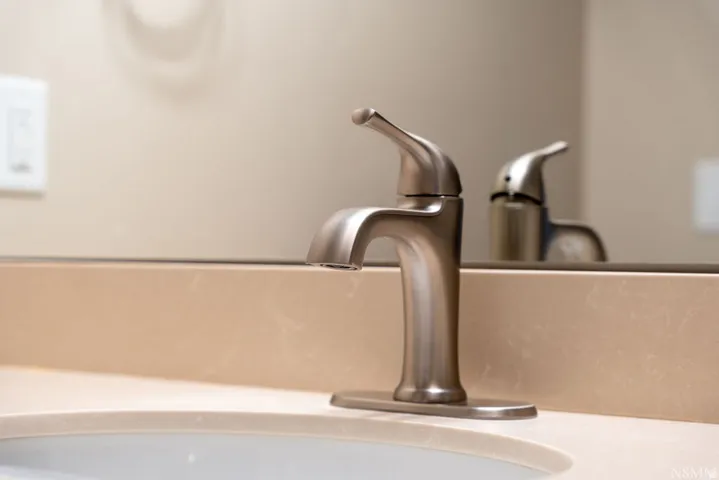 Brushed nickel single-handle faucet with a coordinating countertop and integrated sink