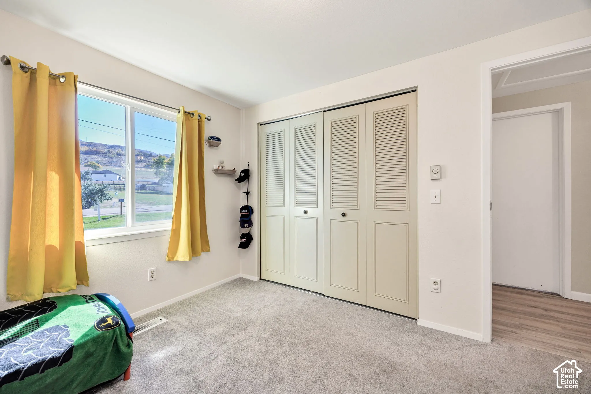 Light-toned walls complement the gray carpeting