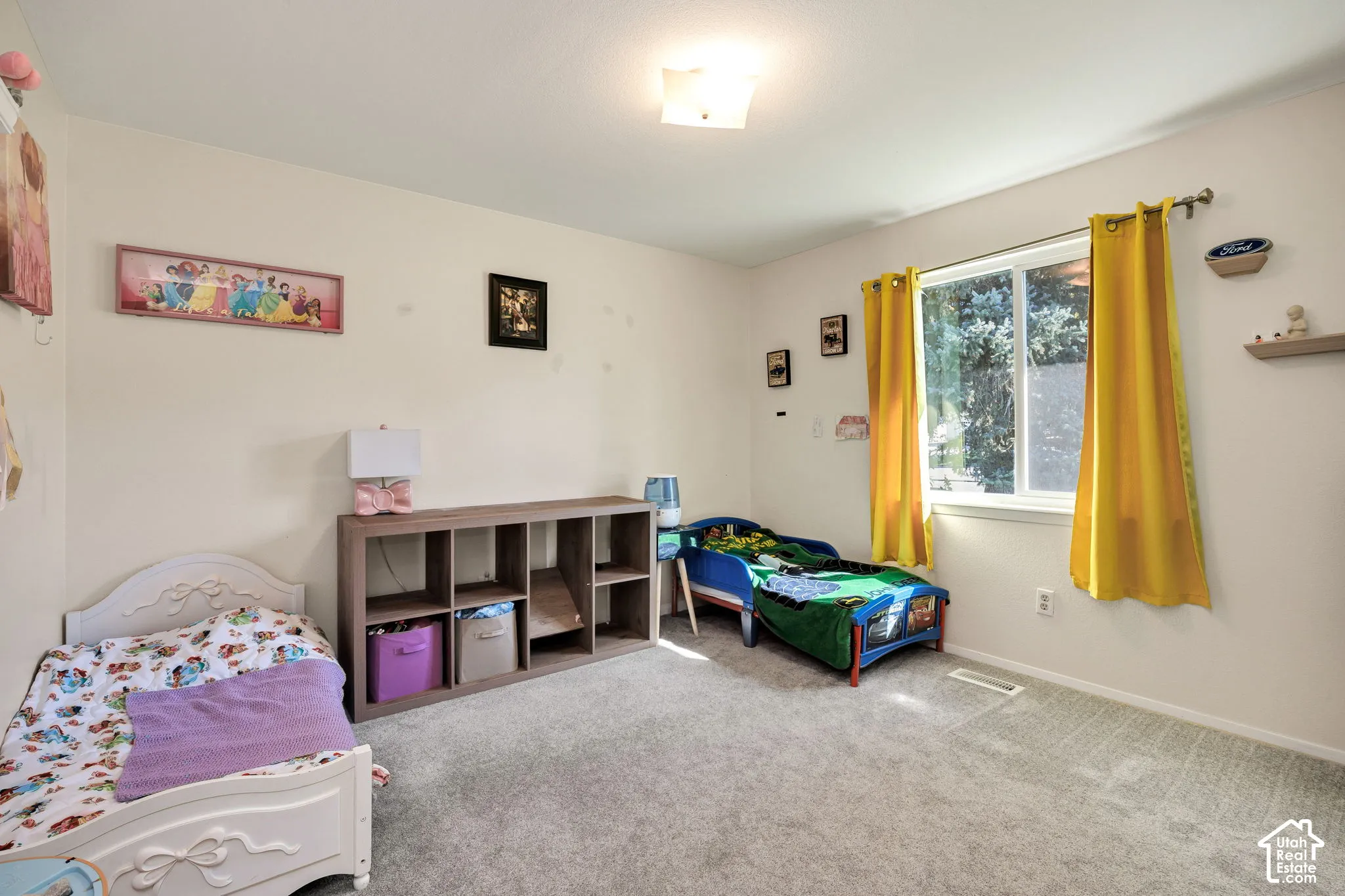Wall-to-wall carpeting and a ceiling-mounted light fixture define this room