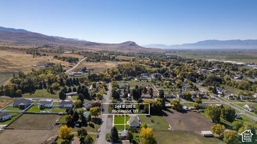 Expansive lot with a rectangular shape, surrounded by paved streets and established homes