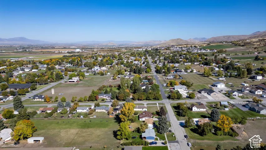Expansive residential area featuring established homes, mature trees, and mountainous terrain