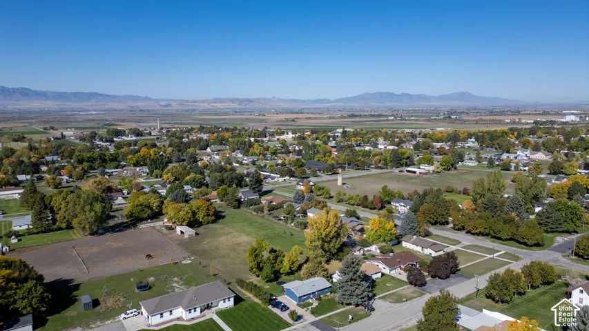 Expansive rural setting featuring a variety of mature trees and distant mountain ranges