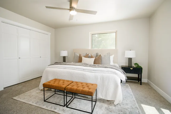 Recessed window, ceiling fan, carpeted flooring, and white panel closet doors