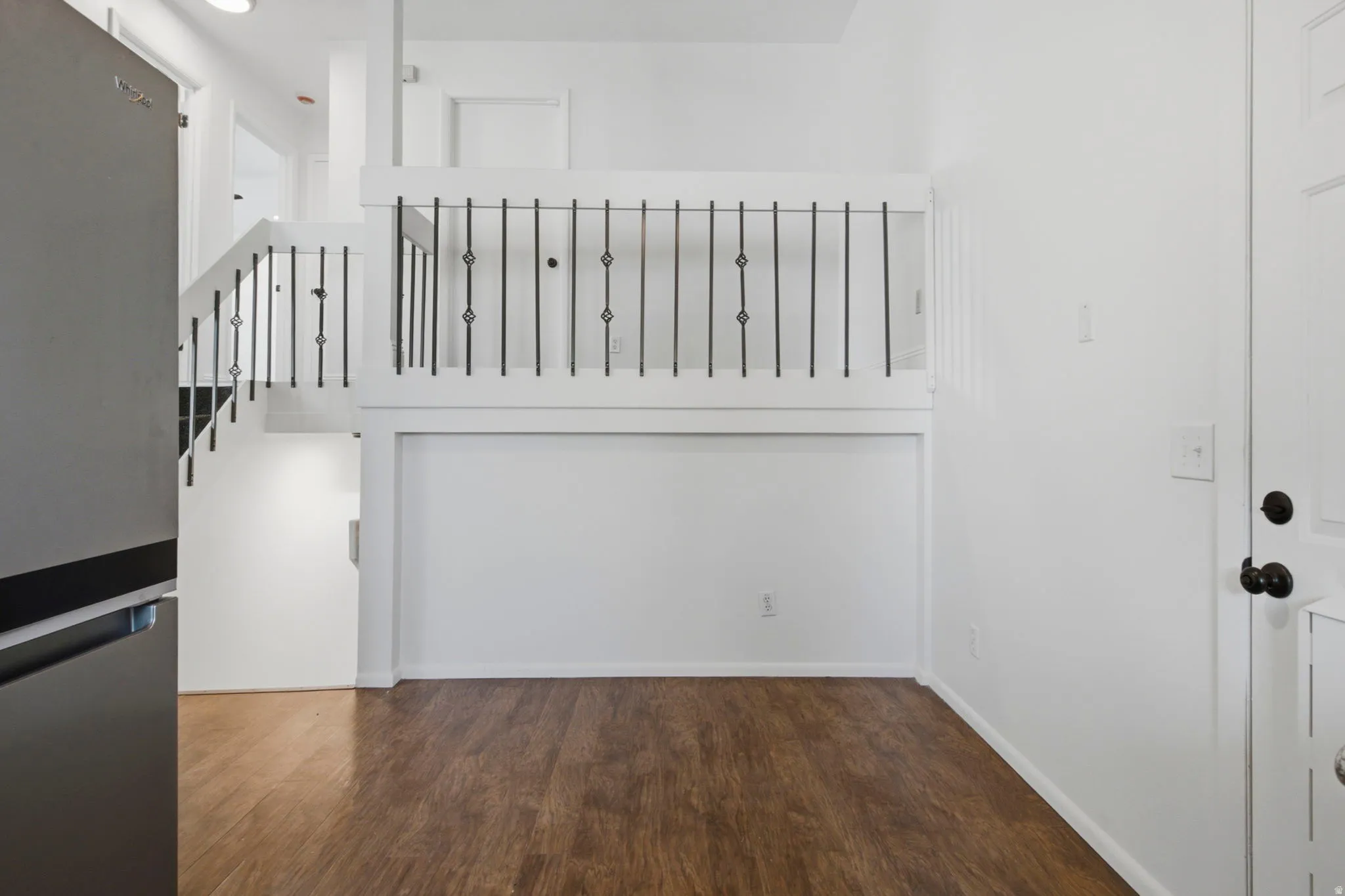 Wood-finish flooring with white walls and trim
