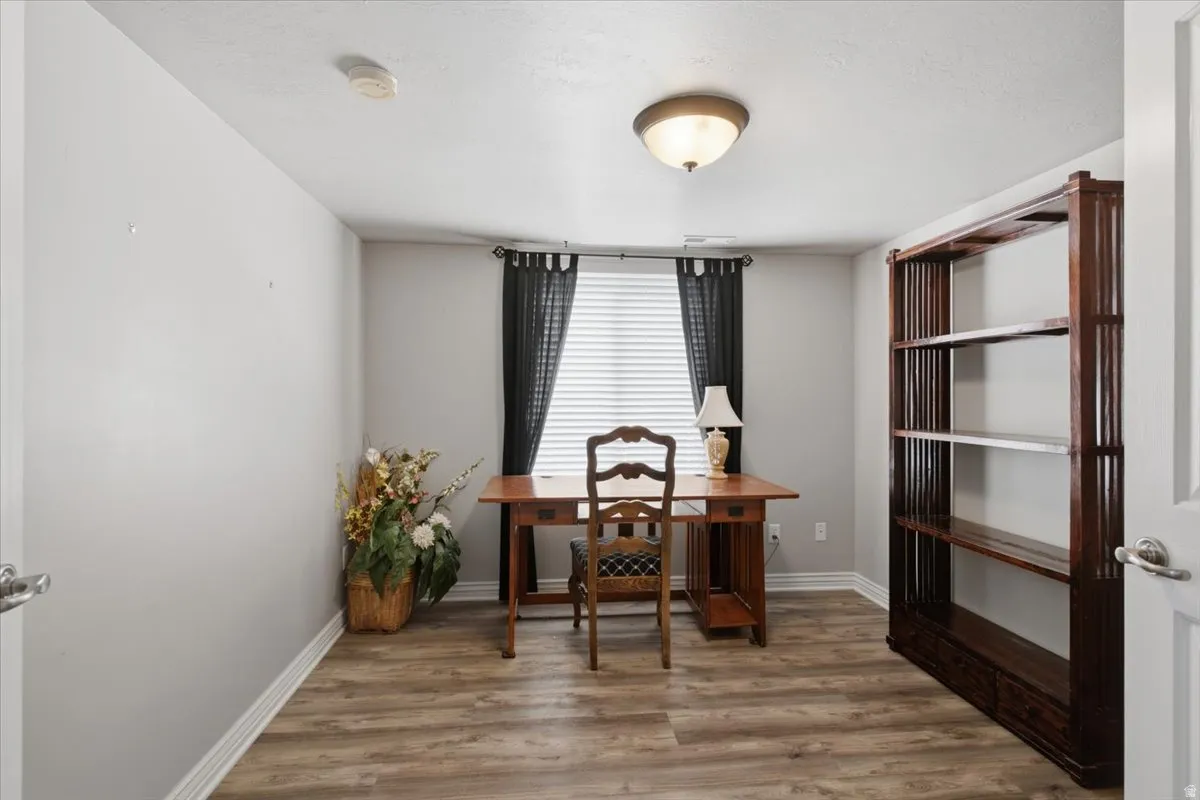 Wood-finish flooring, overhead dome light, and window with blinds