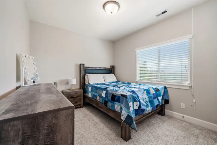Interior room with light gray walls, white trim, and a textured carpet