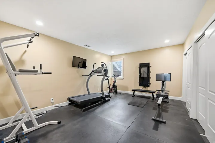 Recreational room featuring recessed lighting, a window with trim, and two paneled bifold closet doors