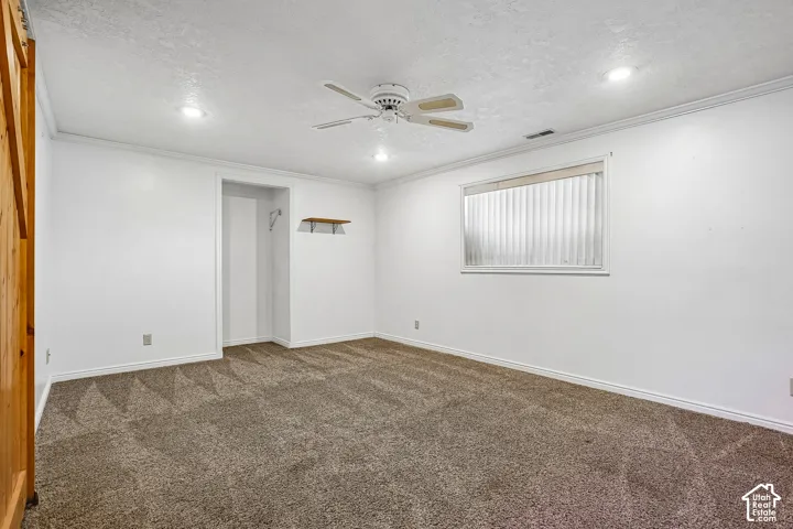 Recessed lighting, ceiling fan, natural wood-finish door, built-in shelving, window with blinds