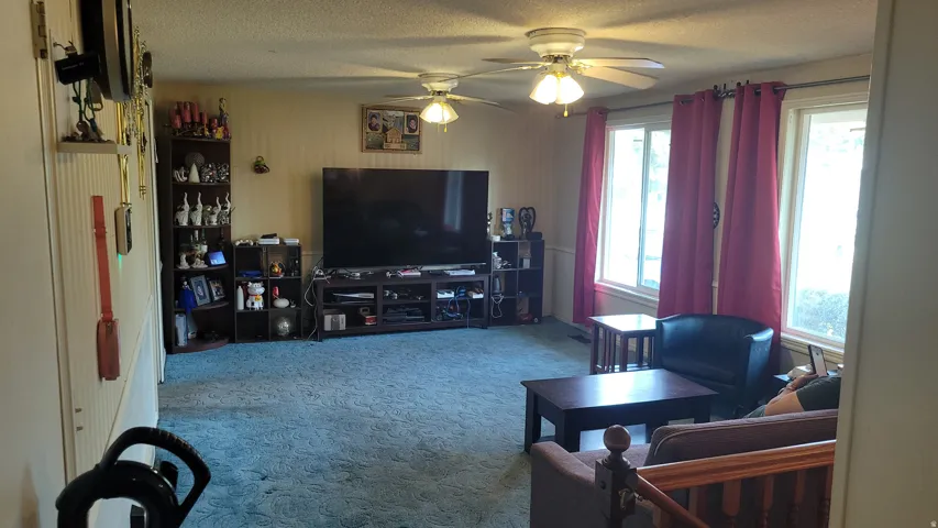 Recessed lighting, crown molding, and two ceiling fans with integrated lighting