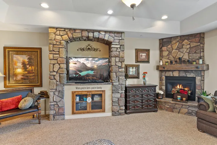 Stone-faced fireplace with a wood mantel