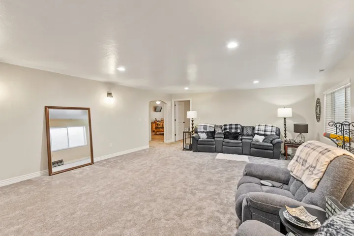 Recessed ceiling lighting, light neutral wall paint, light-colored carpeting, white trim