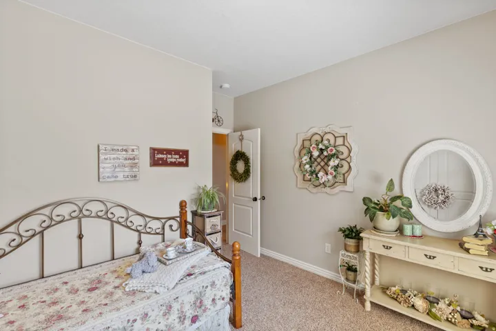Neutral wall color, light-colored carpeting, white trim, and a white interior door