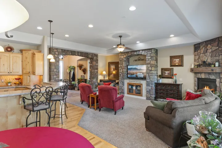 Stone-accented fireplace with a wood mantle