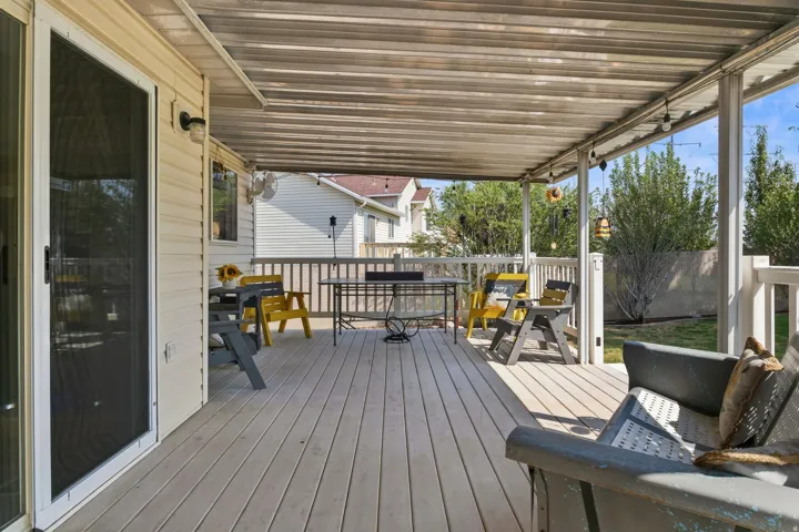 Expansive covered deck with composite decking and white railings
