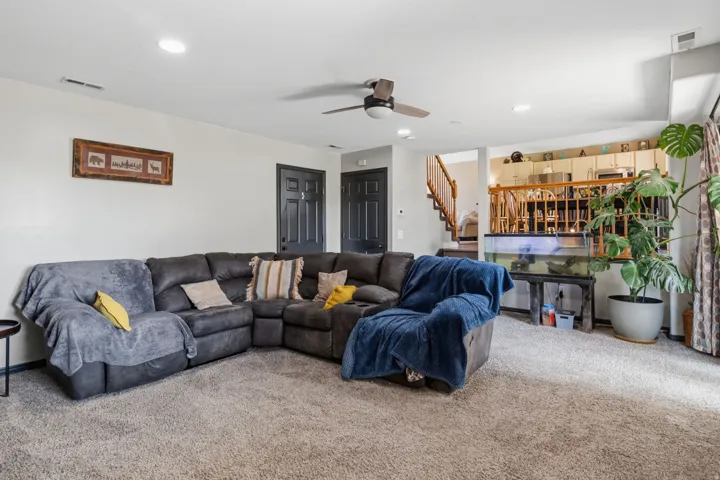 Recessed lighting, ceiling fan, and carpeted flooring