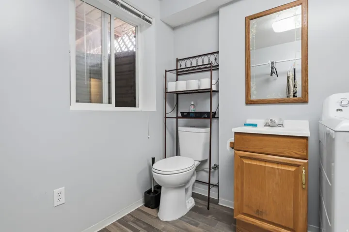 Wood-finish flooring with a white baseboard