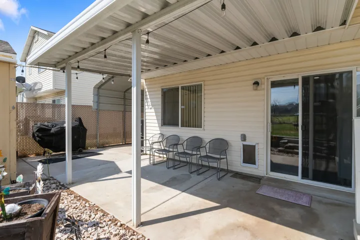 Covered patio with concrete flooring, siding exterior, and sliding glass door