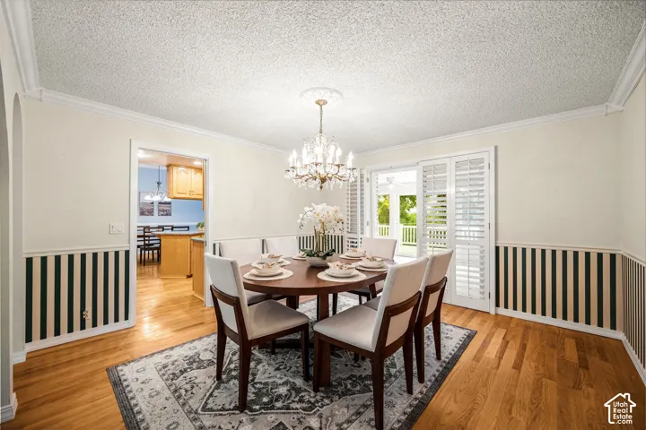 Formal Dining Room with crown molding, chair rail, hardwood floors, and plantation shutters