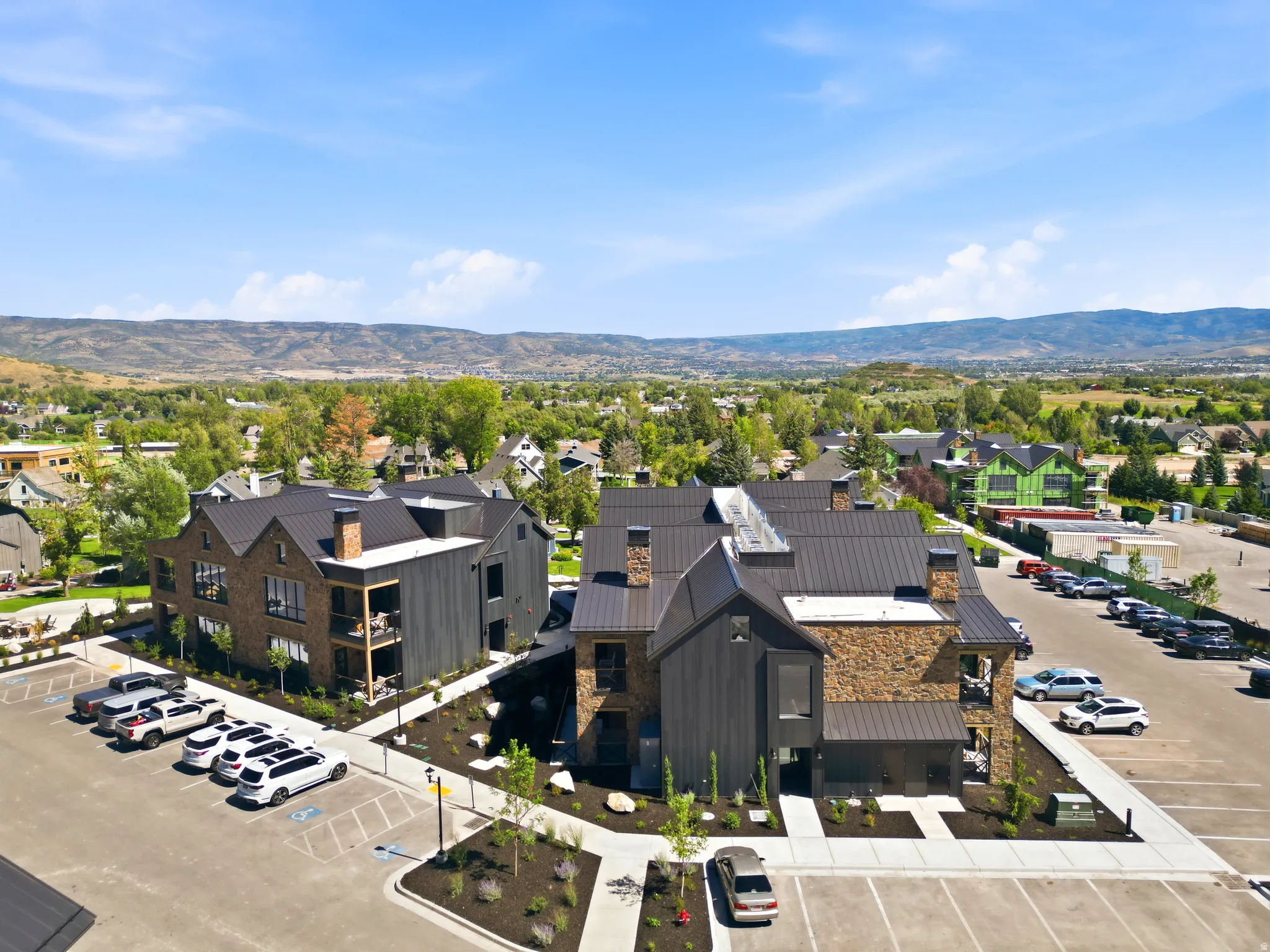 Modern building exteriors with stone and dark-stained wood siding