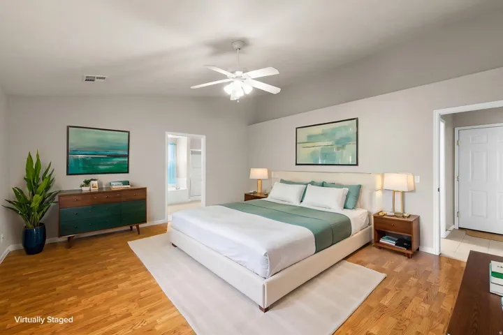 Vaulted ceiling, wood-finish flooring, ceiling fan, and recessed entry