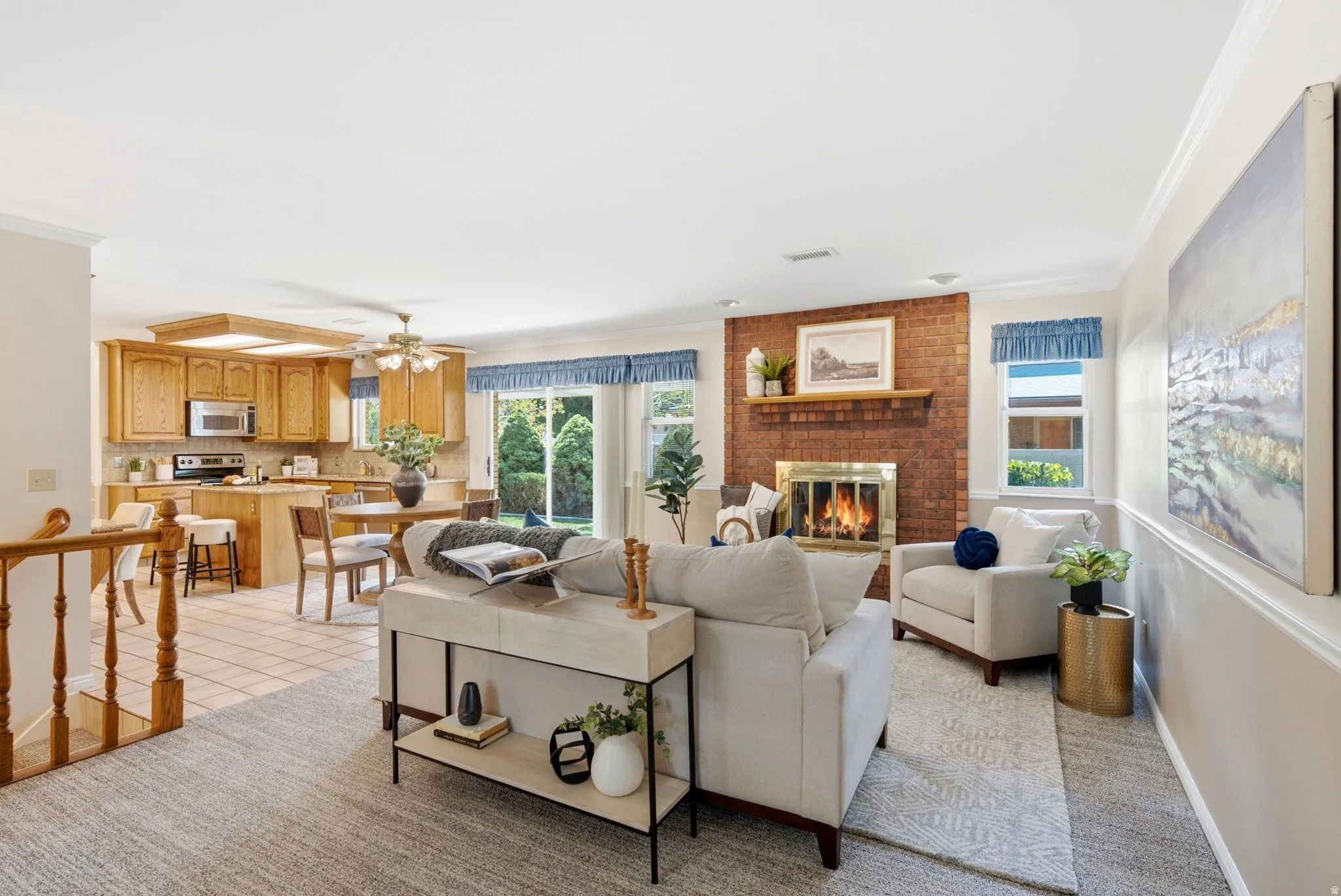 Brick fireplace with a brass-finish insert, wood mantel, and hearth