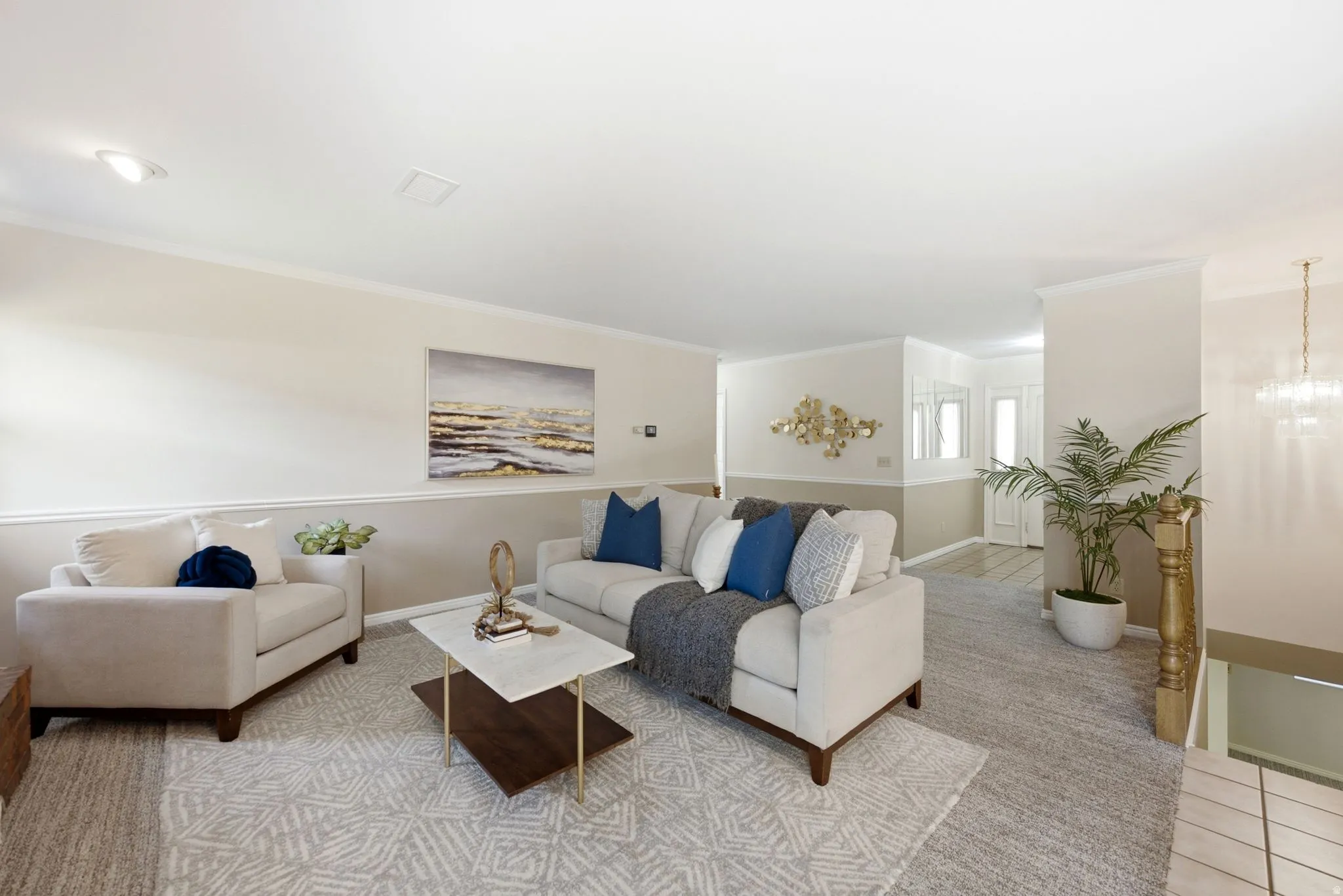Recessed lighting, crown molding, two-tone wall treatment, and a paneled entry door