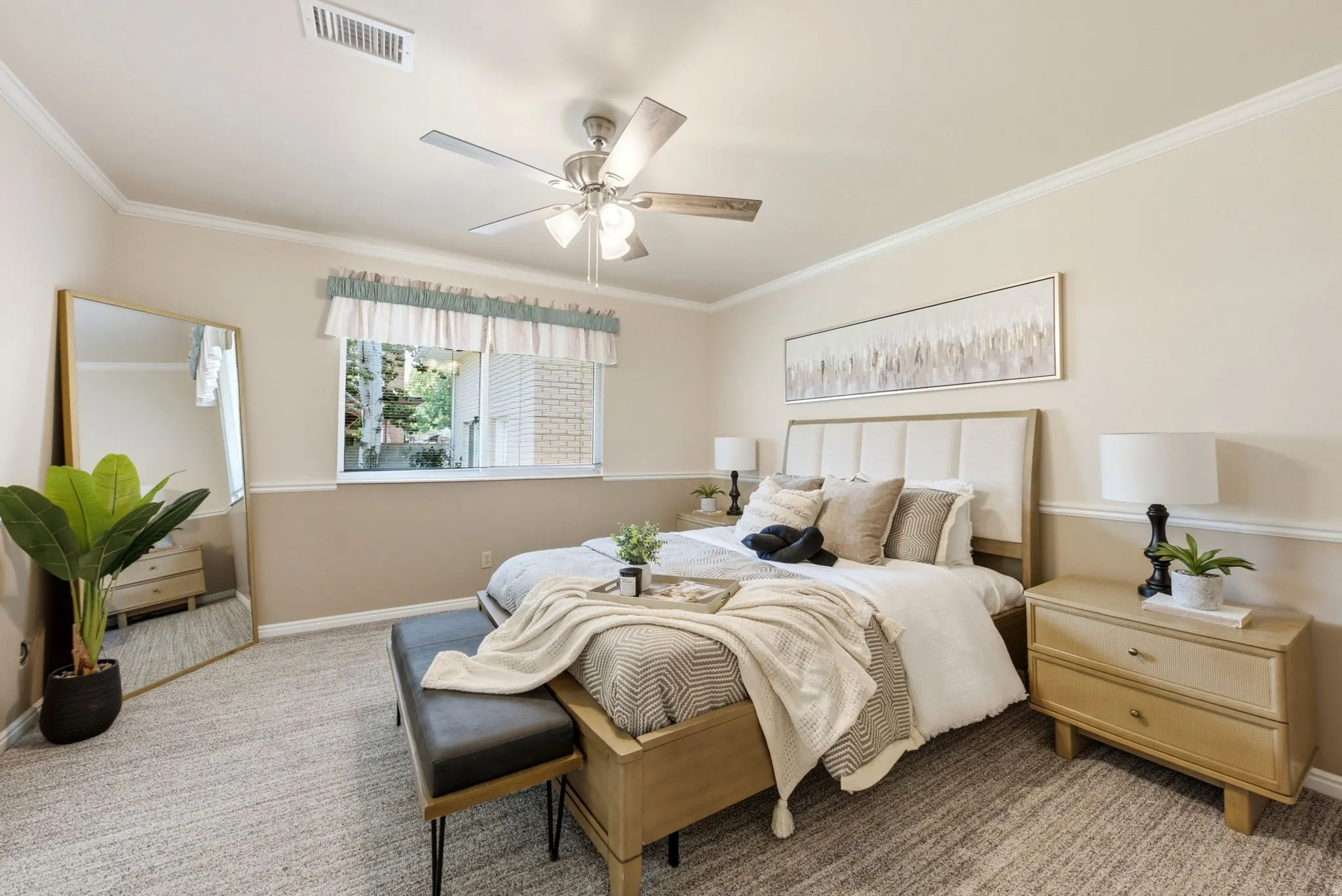 Carpeted room featuring crown molding, chair rail detailing, a window, and a ceiling fan with integrated lighting