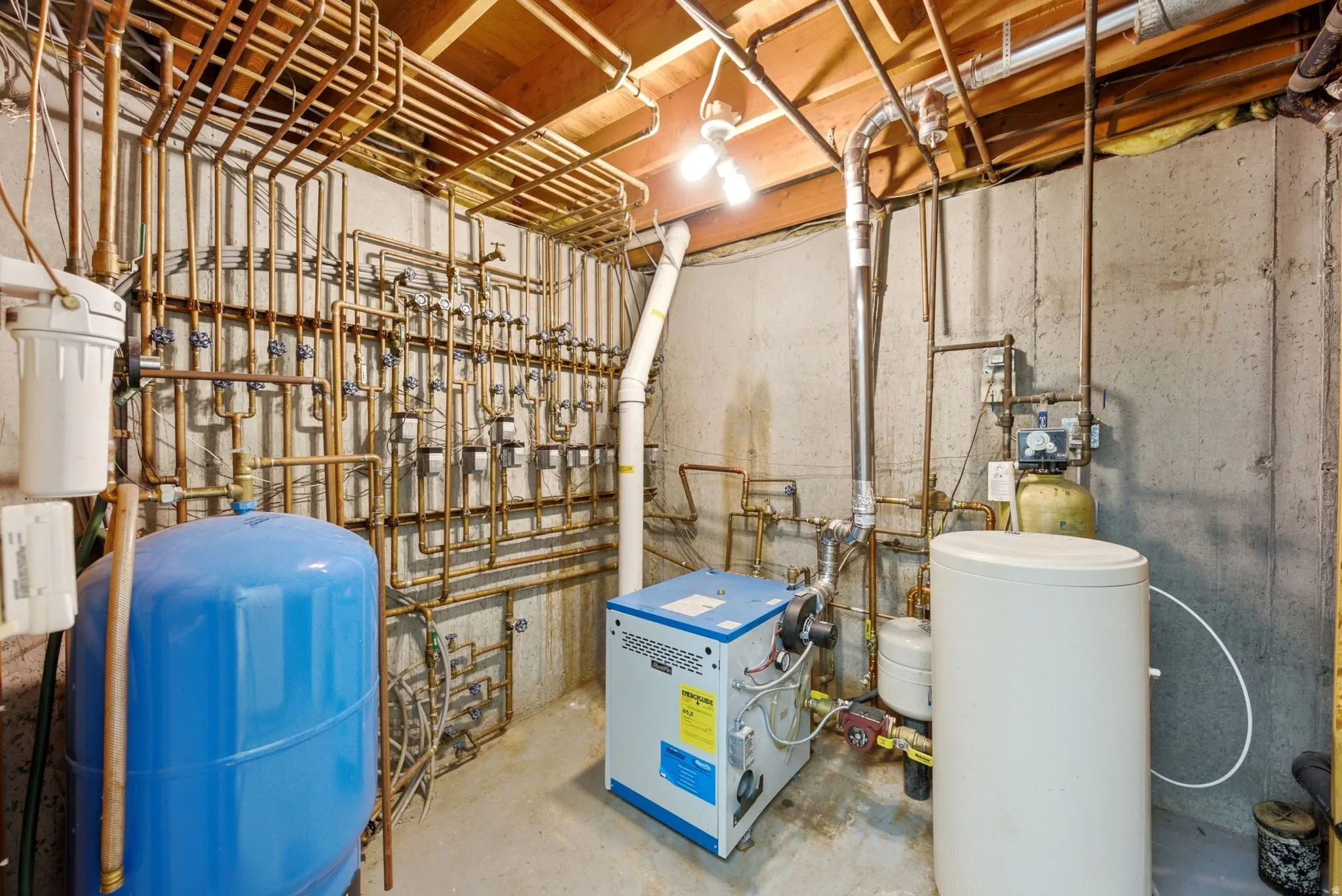 This home has radiant heating in the floors. This is the unit and plumbing setup in basement. This unit was replaced recently