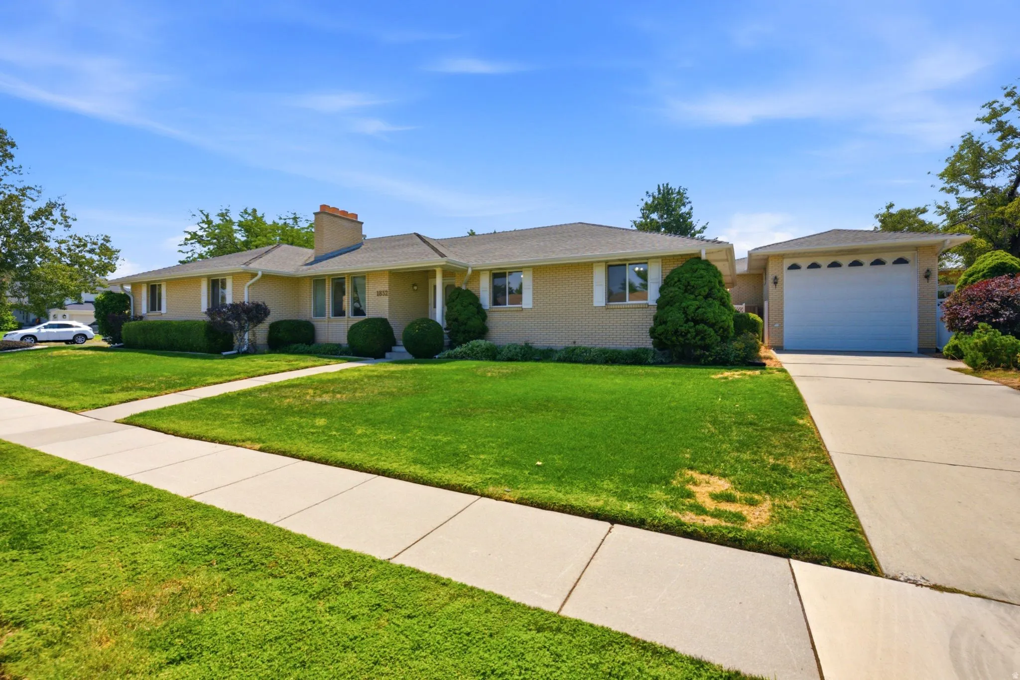 Brick exterior with a gabled roof and attached garage