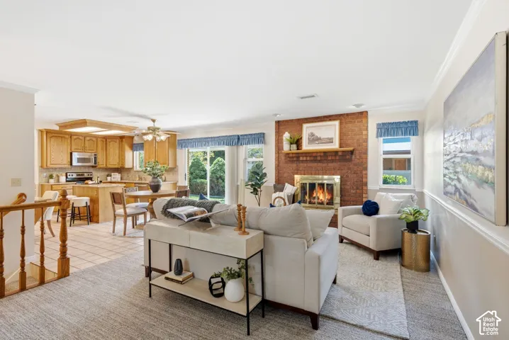Brick fireplace with a brass-finish insert, wood mantel, and hearth
