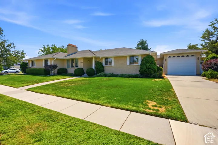 Brick exterior with a gabled roof and detached garage