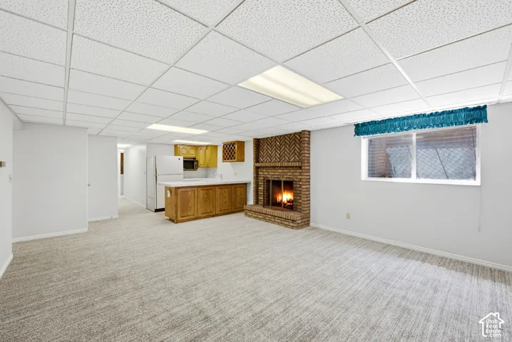 Brick fireplace, appliances, and wall-to-wall carpeting