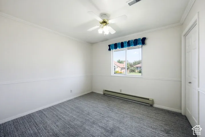 White walls with chair rail molding, ceiling fan with integrated lighting, carpet, and a white paneled door