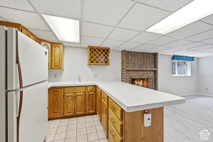 Wet bar with cabinetry and tile flooring
