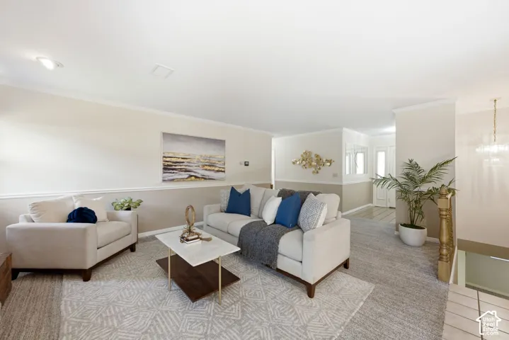 Recessed lighting, crown molding, two-tone wall treatment, and a paneled entry door