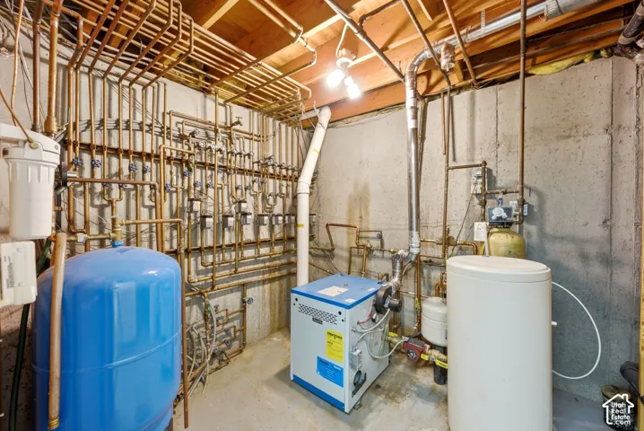 This home has radiant heating in the floors. This is the unit and plumbing setup in basement. This unit was replaced recently