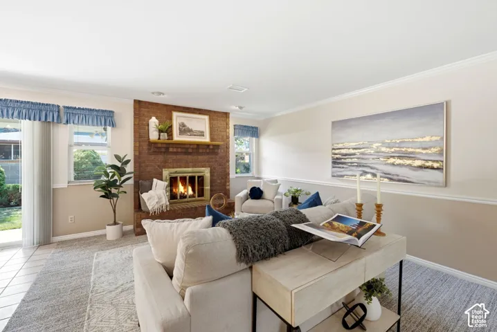 Brick fireplace with a wood mantel, tiled flooring, sliding glass door, and recessed lighting