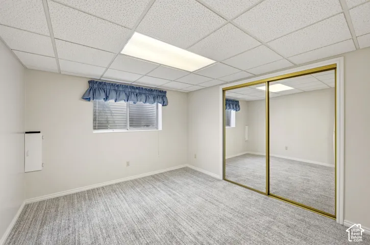 Recessed lighting, carpeting, window with blinds, and mirrored sliding closet doors