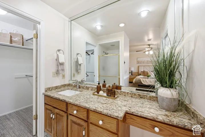 Vanity with granite countertop and  undermount sink.
