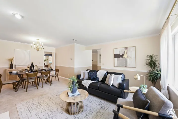 Ceiling lighting, crown molding, and a brass chandelier