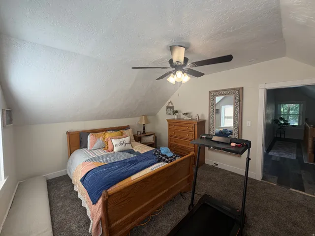 Room with sloped ceilings and textured walls