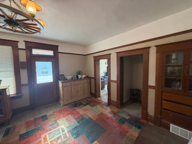 Rich wood trim and door frames complement the light wall tones