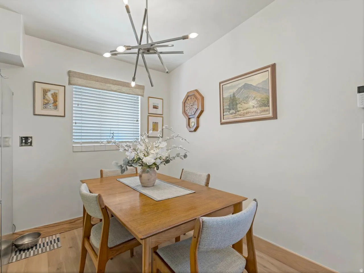 Recessed lighting, wood-finish flooring, and a modern sputnik chandelier