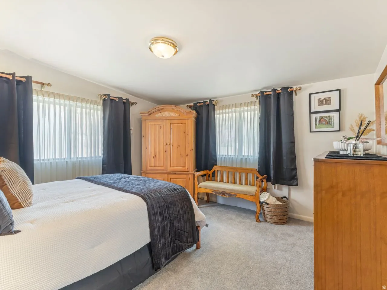 Recessed lighting, light-colored walls, and neutral carpeting